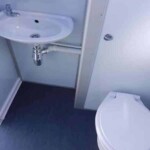 Elegant interior of a VIP mobile toilet with stylish fixtures, mirrors, and spacious layout.